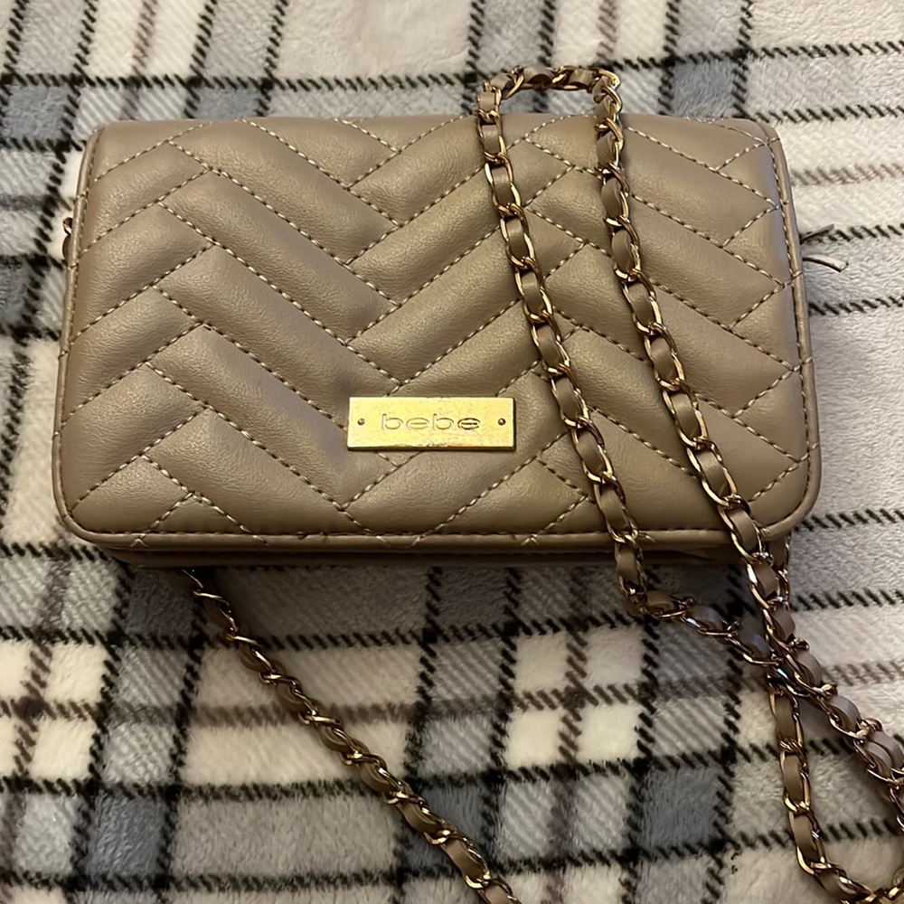 BEBE tan satchel with gold chains.